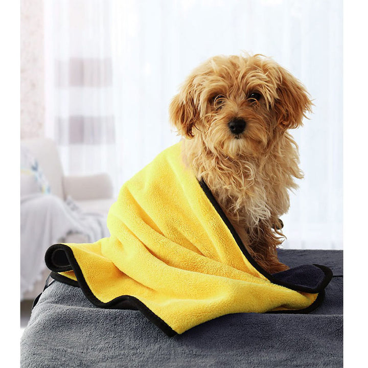 Pet supplies absorbent towel wrapped around a small dog, ideal for drying after baths or outdoor activities.